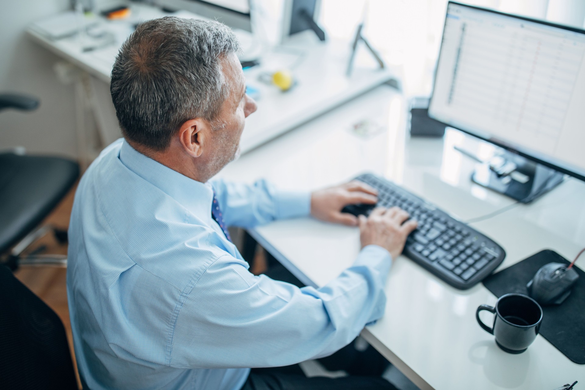 Senior businessman using computer at the office
